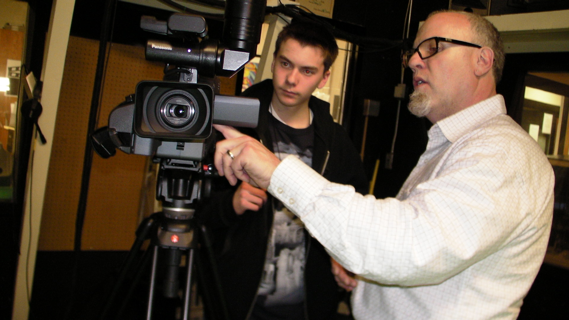 SANY0430 Morristown High School freshman Chris Gordon gets a video lesson from broadcasting teacher Mike Butler. Photo by Kevin Coughlin