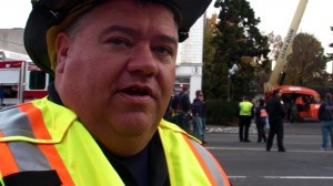 HAPPY ENDING: Veteran Firefighter Jimmy Schultz, one-month into his term as acting fire chief in Morristown, speaks after two steeple workers were lowered to safety. Photo by Kevin Coughlin