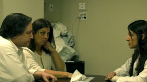 KEEPING IT REAL: Dr. Christine Seminara, right, a second-year resident at Morristown's Goryeb Children's Hospital, delivers bad news to parents portrayed by actors Kevin Bohl and Leslie Reagoso in a training exercise. Photo by Kevin Coughlin